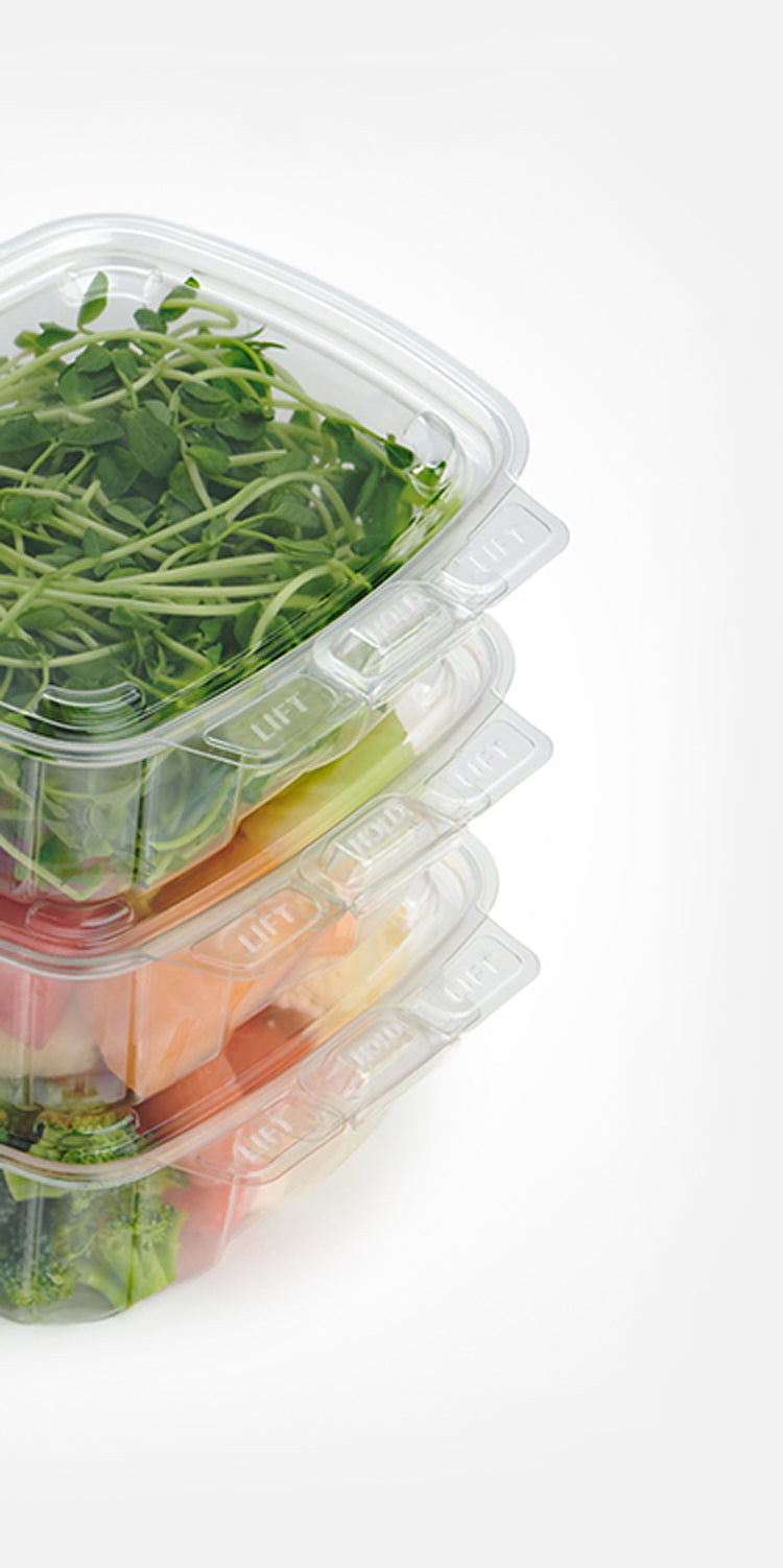 3 stack of containers filled with microgreens, fruit and veggies.