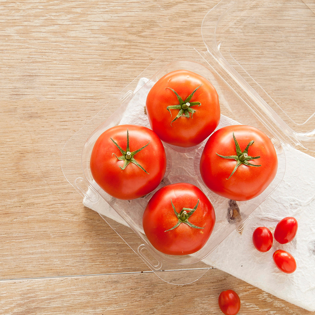 4 perfectly ripened tomatoes in a container, ready to make a salad.