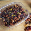 16 oz. food containers made of clear, compostable plastic containing trail mix