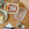 Table with a spagetti and sauce in a 16 oz GoodToGo Micrwavable container