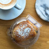 dessert to-go container made of clear, compostable bioplastic with pan au chocolat